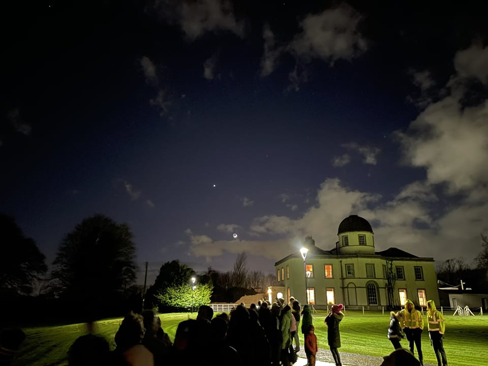 Dunsink Observatory, people standing outside a beautiful old building, looking up at the starry sky